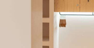 a room with a wooden shelf and a bench